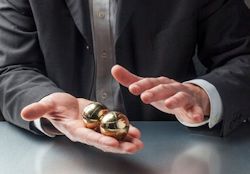 Image of man holding steel balls in his hands.