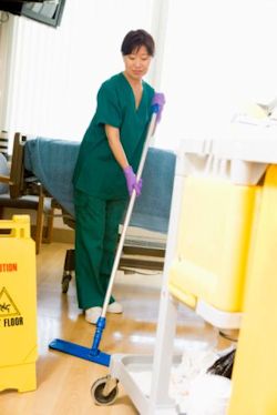 Image of worker mopping floor.