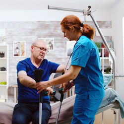 Image of Nurse helping patient stand