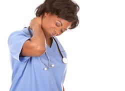 Medical staff rubbing back of neck as if in stress