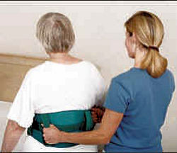 Nurse helping patient using gait belt