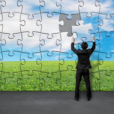 Image of a person putting the pieces of a puzzle together.