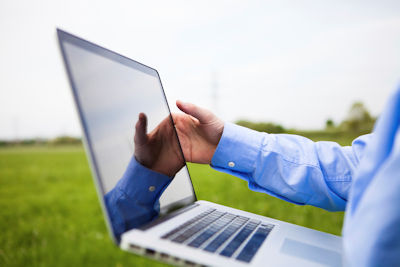 Image showing a manager outdoors working on a laptop computer