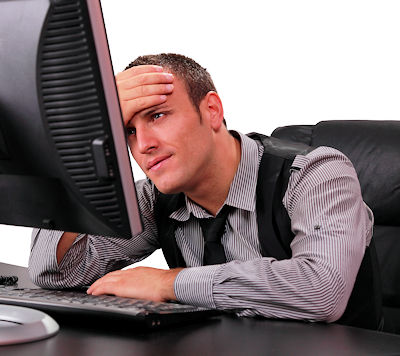 Tired employee looking at computer screen