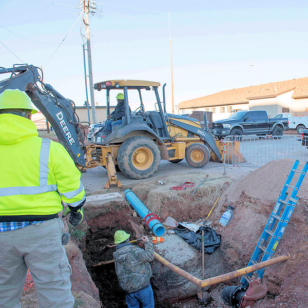 Outdoor construction worksite with employees and machinery