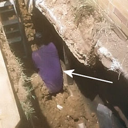 Worker buried by cave-in up to his waist there was no support system in place.