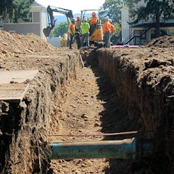 Workers checking for and marking the location of underground utilities.