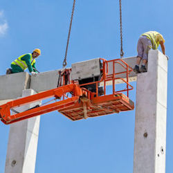 Two workers at very risky height placing materials that were hoisted up