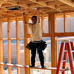 Worker standing on self-made unstable ladder.