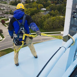 Worker at elevated height where you can clearly see the fall arrest system