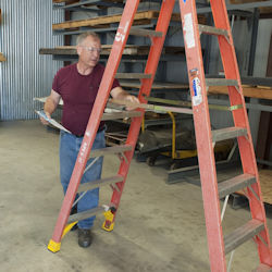 worker inspecting ladder