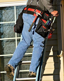 Worker using a ladder unsafely