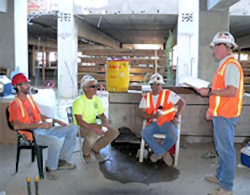 Four employees discussing job assignment