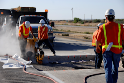 Four workers working in roadway