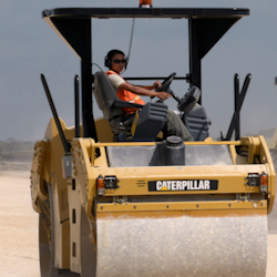 Worker operating road roller