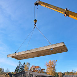 Crane lifting cement slab