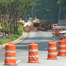 Warning barricades and barrels blocking road