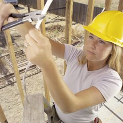 Worker on ladder cutting electrical wire