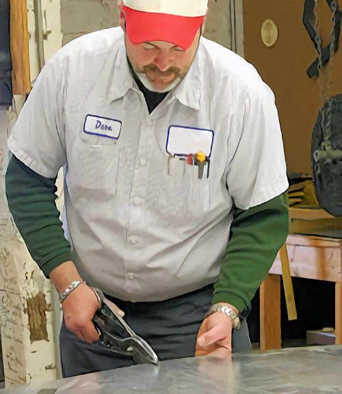 Worker cutting sheet metal