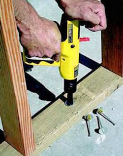 Worker using a powder actuated tool