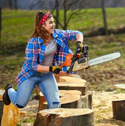 Laughing woman with chainsaw chasing a another worker.