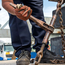 Worker awkwardly holding drill