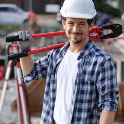 Worker with large bolt cutter resting on shoulder