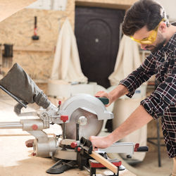 Employee using a power saw