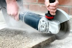 Worker using a professional angle grinder