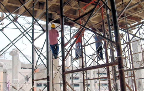 Worker climbing shoring