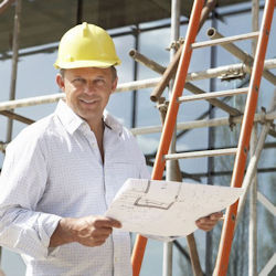 worker standing by a single straight ladder