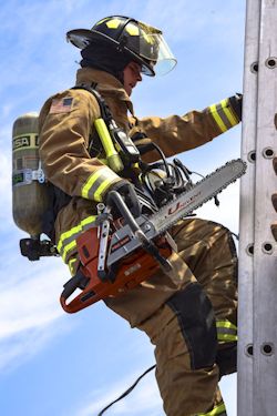 fireman using three-point contact while climbing ladder