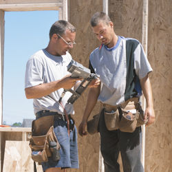 workers inspecting a nail gun