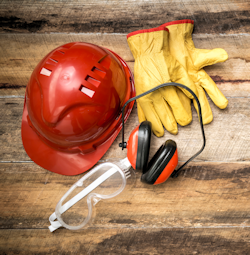 A display of PPE helmet, gloves, and safety, glasses and ear protection