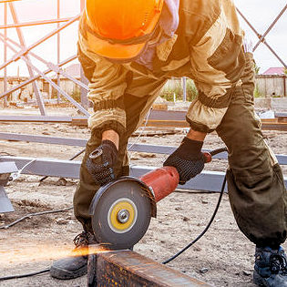 Image of outside construction worker using power tools