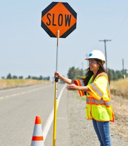 Worker called a flagger regulating traffic