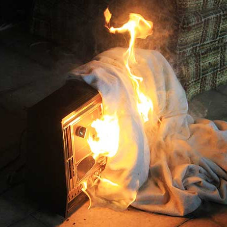 portable space heater on fire because of contact with fabric material