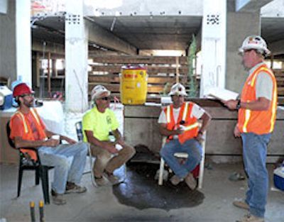 Several workers in a pre-lift meeting