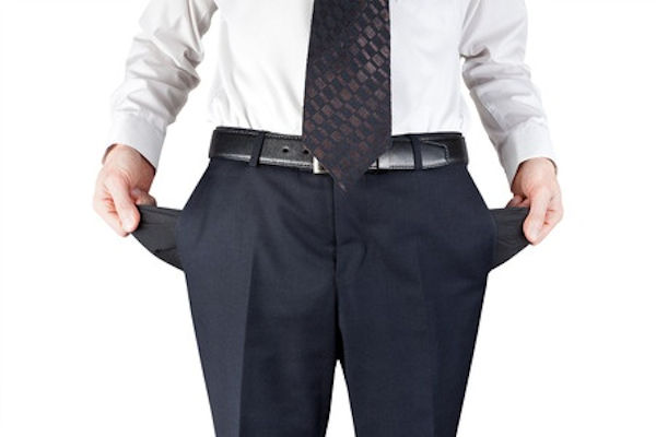 Man with suit pant pockets pulled out