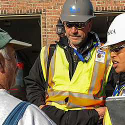 OSHA consultant visiting an accident site meeting with two employees