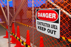 Keep out sign posted on fence surrounding work site