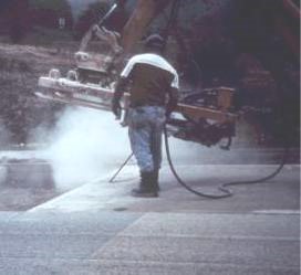 Picture of worker exposed to silica dust when spraying compressed air