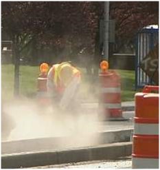 Worker exposed to hazardous silica dust when cutting concrete outdoors