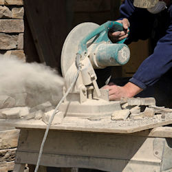 Image of a worker operating a saw with no dust controls.