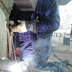 Welder with full ppe working outside