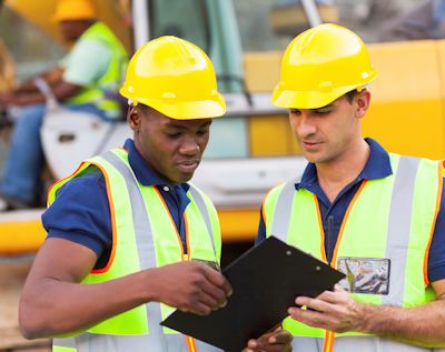 Two wellsite safety officers discussing responsibilities