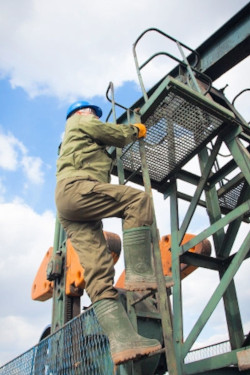 Subcontractor climbing outdoor ladder