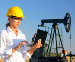 Worker outside viewing information on laptop 