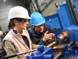 Two workers practicing on the job training