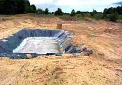 Large field with a mud pit excavation